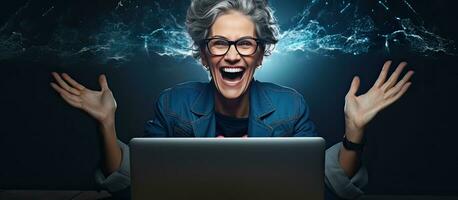 An enthusiastic middle aged woman working on her laptop at night happily pointing to the side with open palms to display a copy space for advertising purp photo