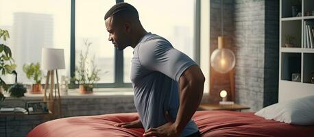 African American man with back and neck pain in bed Space photo