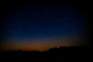 noche paisaje con vistoso y ligero amarillo lechoso camino lleno de estrellas en el cielo. foto