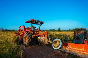 Agricultural machinery in the rice fields at sunset photo