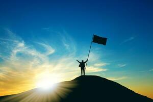 Concept of success, Silhouette of business man with a victory flag on the top of the mountain photo