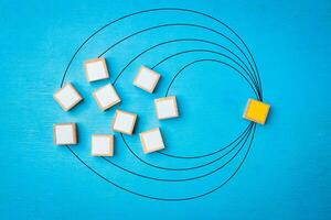 Network link concept, Wooden blocks on blue wooden background. photo