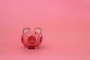 Pink piggy bank on pastel pink background, Financial concepts. photo