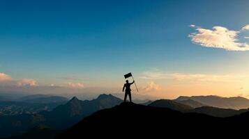 silhouette of businessman with flag on mountain top over sunset sky background, business, success, leadership and achievement concept. photo