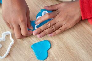 Children's hands and simulation cooking toys in the kitchen counter photo