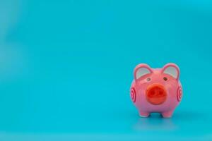 Pink piggy bank on pastel blue background, Financial concepts. photo