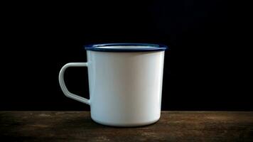 Cup of coffee on old wooden table photo