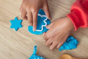 Children's hands and simulation cooking toys in the kitchen counter. photo