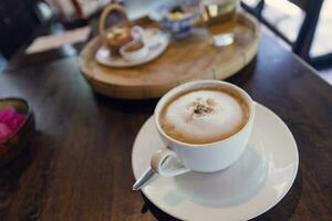 Cappuccino coffee served in a Thai style coffee shop photo