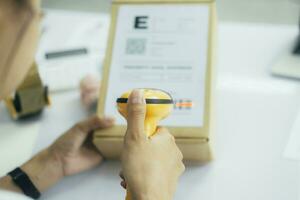 Scanning parcel barcode before shipment. photo