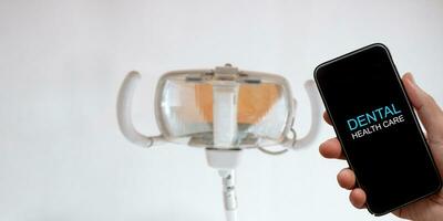 dental health care concept, Smart phone on blur dental clinic photo