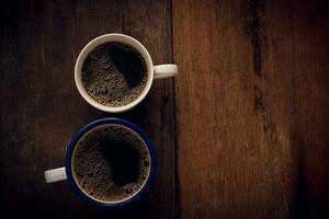 Cup of coffee on wooden background. Copy space. Top view. Flat lay photo