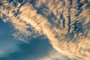 Beautiful golden clouds in the blue sky photo