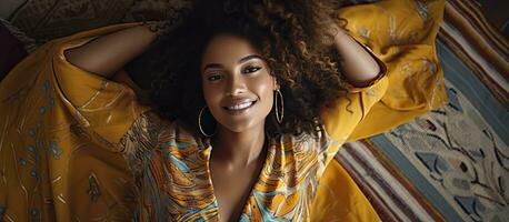 Happy African model wearing an animal print dress lying down while smiling and looking at the camera Indoor portrait with copy space photo