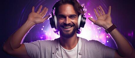 Man dancing happily and wearing headphones DJ smiling hipster displaying the world sign with fingers portrait on purple background with neon light photo