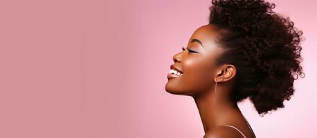 African teenage girl in profile looking at pink studio background with copy space photo