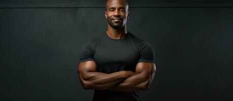 African American fitness trainer confidently poses with crossed hands photo