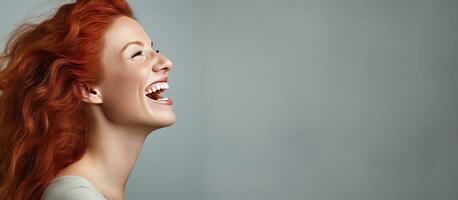 Excited red haired woman screaming and reaching towards empty space photo