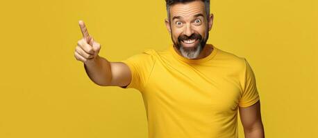 Happy man gesturing to empty space with hands offering advertising opportunities isolated on yellow background photo