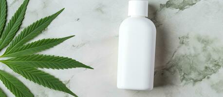 Eco friendly CBD lotion mockup with organic skincare product on marble table alongside green cannabis leaves photo