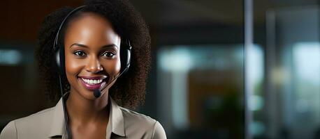 Smiling African American customer service agent with headset attending calls in office looking at camera photo