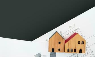 real estate and property, architecture, building, construction concept - Tiny house model on an architect's desk photo