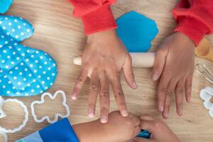 Children's hands and simulation cooking toys in the kitchen counter. photo