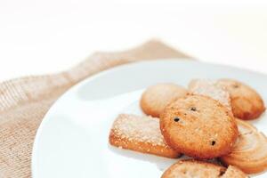 Butter cookies in a white plate on a white background. photo