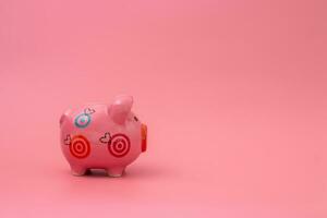 Pink piggy bank on pastel pink background, Financial concepts. photo