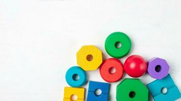 Colorful kids toys on white wooden background. Top view. Flat lay. Copy space for text photo