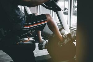 Man exercising in fitness with exercise bike photo