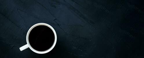 White coffee cup on black background, banner background with copy space. photo