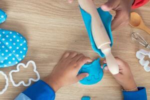 Children's hands and simulation cooking toys in the kitchen counter. photo