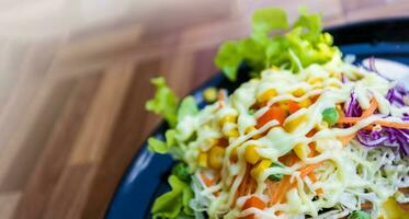 Healthy food vegetable salad on black plate photo