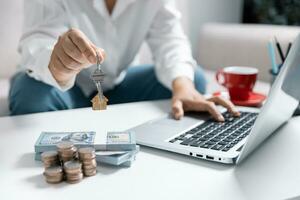 Coins on table, close up view, woman on background calculates expenses, managing finances, household bills or taxes, save money for future, take care for tomorrow, frugality concept. photo