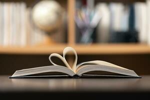 Education learning concept. Book in library with old open textbook, stack piles of literature text archive on reading desk, aisle of bookshelves in school study class room background for academic photo