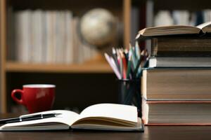 Education learning concept. Book in library with old open textbook, stack piles of literature text archive on reading desk, aisle of bookshelves in school study class room background for academic photo