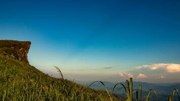 The high cliffs in the mountains protrude into the sky at sunset. photo