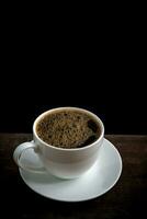 Cup of coffee on old wooden table photo