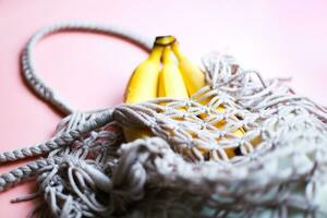 Bananas in a string bag. Zero waste. Caring for nature. Refusal of plastic photo