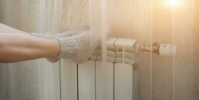 legs in socks on warm radiator photo