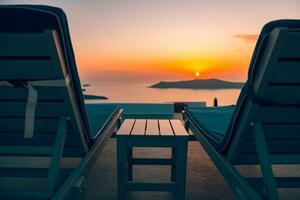 Perfect sunset view. Idyllic landscape with loungers or sun bed, chairs with table on a hotel or resort terrace. Mood and vibes of summer vacation holiday. Romantic sunset scenery for couples photo