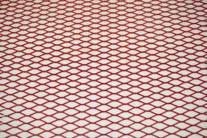 Red chrome Steel Grating seamless structure with soft focus. Steel grate on white background in perspective with Selective focus, mesh, wallpaper, cage, pattern, cell, chain link, isolated. photo