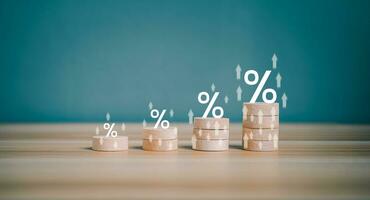 Interest rate financial and mortgage rates concept. Wooden block increasing on top with percentage symbol and arrow upward direction. Return on stocks and mutual funds from business growth concept. photo