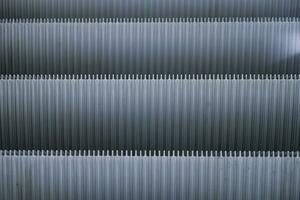 Abstract Shiny Gray pattern of metal escalator foot step texture background photo