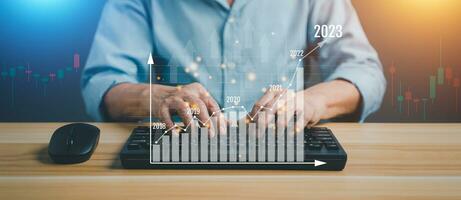 2023 business man hand using computer working finance technology and investment achievement concept. Stock Market Investments Funds and Digital Assets. Analyzing forex trading graph financial data. photo