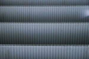 Abstract Shiny Gray pattern of metal escalator foot step texture background photo