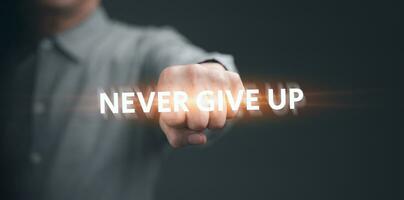 Close up of businessman fist bump hand. Male entrepreneur doing fist with encouragement message NEVER GIVE UP quotation photo