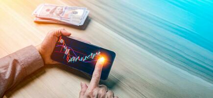 Trader investor Pointing on the smart phone show financial market chart. Stock market, cryptocurrency, Bitcoin graphs on device. Technology investing for money concepts. with banknote background. photo