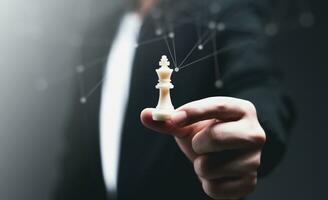 Business Strategy, Marketing, Leadership Concept. Businessman holding The King chess with connection line to show Strategy, target Marketing, goal, Leader, strategic, competition, management, success. photo